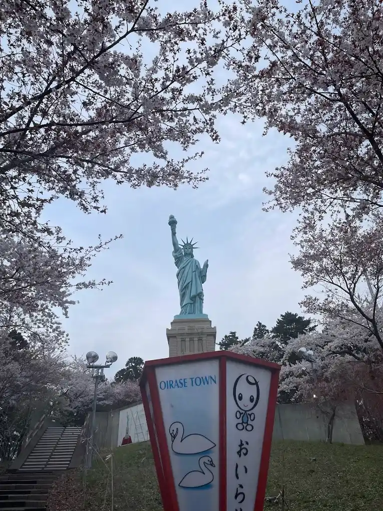 estatua de la libertad en oirase aomori cerca de un lago con cisnes