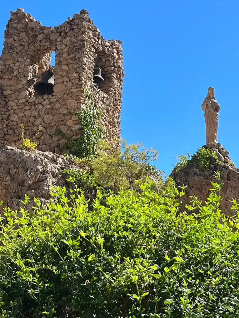 campanario de piedra de la ermita de la virgen de la peña en pleno centro de mijas